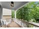 Inviting porch with rocking chair, featuring brick flooring and lush greenery views at 1104 Victoria Ne St, Brookhaven, GA 30319