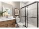This primary bathroom features a large black frame shower and shaker cabinets at 5360 Hyde Rd, Cumming, GA 30040