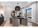 Cozy dining area with a round table, stylish chairs, a modern light fixture, and natural light at 5360 Hyde Rd, Cumming, GA 30040
