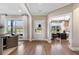 Bright foyer featuring hardwood floors, large windows, and an adjacent home office at 5360 Hyde Rd, Cumming, GA 30040