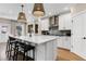 Modern kitchen featuring a large island, stainless steel appliances, and white cabinets at 5360 Hyde Rd, Cumming, GA 30040
