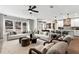 Open-concept living room and kitchen with modern decor, hardwood floors, and plenty of natural light at 5360 Hyde Rd, Cumming, GA 30040