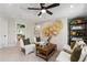 This sitting room features four armchairs, windows, bookshelf and natural lighting at 5360 Hyde Rd, Cumming, GA 30040