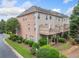 The back exterior has beautiful green landscaping and wooden decks perfect for outdoor living at 6054 China Rose Ln, Duluth, GA 30097