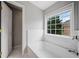 Bright bathroom featuring a tiled tub, providing a tranquil and well-lit space with ample natural light at 6054 China Rose Ln, Duluth, GA 30097
