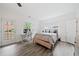 Light and bright bedroom featuring wood-look flooring, desk area, and access to the backyard at 6054 China Rose Ln, Duluth, GA 30097