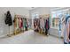 Spacious walk-in closet with two windows and well-organized clothing racks, ideal for fashion enthusiasts at 6054 China Rose Ln, Duluth, GA 30097