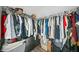 Organized walk-in closet with hanging rods and storage shelves at 6054 China Rose Ln, Duluth, GA 30097