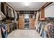 Spacious walk-in closet with custom built-in shelving and ample storage space for clothing at 6054 China Rose Ln, Duluth, GA 30097