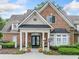 The clubhouse has a brick exterior, and inviting entrance perfect for community gatherings at 6054 China Rose Ln, Duluth, GA 30097