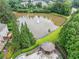 A community pond with a fountain, gazebo, and surrounding trees offers a tranquil outdoor space at 6054 China Rose Ln, Duluth, GA 30097