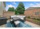 Outdoor deck area featuring patio furniture and a view of the neighboring buildings and trees at 6054 China Rose Ln, Duluth, GA 30097