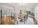 Spacious dining area adjoining an open kitchen, featuring hardwood floors and abundant natural light at 6054 China Rose Ln, Duluth, GA 30097