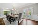 Formal dining room with a chandelier, ample natural light, and access to the outdoors through glass doors at 6054 China Rose Ln, Duluth, GA 30097