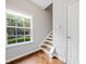 Hardwood entryway with window and staircase leading to upper level at 6054 China Rose Ln, Duluth, GA 30097