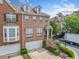 Charming brick townhome with a two-car garage and manicured front yard at 6054 China Rose Ln, Duluth, GA 30097