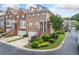 Charming brick townhome with a one-car garage, manicured landscaping, and inviting curb appeal at 6054 China Rose Ln, Duluth, GA 30097