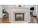 Elegant fireplace with a white mantle, tile surround, and view of a piano at 6054 China Rose Ln, Duluth, GA 30097