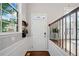 Bright foyer with hardwood floors, white wainscoting, and transom window above the front door at 6054 China Rose Ln, Duluth, GA 30097