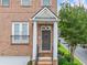 Inviting front entrance with decorative pillars, a charming light fixture, and a well-maintained brick facade at 6054 China Rose Ln, Duluth, GA 30097