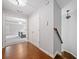 Inviting hallway with hardwood floors and stairs leading to an elegant Primary bedroom with trey ceilings at 6054 China Rose Ln, Duluth, GA 30097