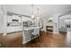 Bright, modern kitchen with a fireplace, white cabinetry, granite countertops, and hardwood floors at 6054 China Rose Ln, Duluth, GA 30097