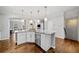 Kitchen island features stainless steel appliances, granite countertops, and modern pendant lighting at 6054 China Rose Ln, Duluth, GA 30097