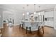 Bright kitchen features white cabinetry, stainless steel appliances, and a large island with seating at 6054 China Rose Ln, Duluth, GA 30097