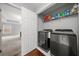 Convenient laundry room with modern washer and dryer, offering easy access to a well-lit bedroom at 6054 China Rose Ln, Duluth, GA 30097