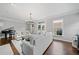 Open-concept living room featuring neutral-toned decor, a fireplace, and a grand piano at 6054 China Rose Ln, Duluth, GA 30097
