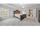 Spacious Primary bedroom features trey ceilings, plush carpet, and an inviting chandelier at 6054 China Rose Ln, Duluth, GA 30097