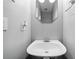 Small powder room featuring a modern sink and mirror, with light gray walls at 6054 China Rose Ln, Duluth, GA 30097