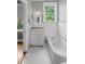 Bright bathroom with white fixtures, tub, and marble countertop at 655 E Pelham Ne Rd, Atlanta, GA 30324