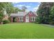 Charming brick home with a lush green lawn and beautiful landscaping at 655 E Pelham Ne Rd, Atlanta, GA 30324