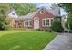 Brick home with manicured lawn, covered patio, and convenient driveway at 655 E Pelham Ne Rd, Atlanta, GA 30324