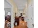 Long hallway with wood floors, leading to furnished rooms at 655 E Pelham Ne Rd, Atlanta, GA 30324
