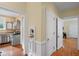 Hallway showing doorways into kitchen and other rooms, with hardwood floors at 655 E Pelham Ne Rd, Atlanta, GA 30324