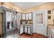 Gray and white kitchen with stainless steel fridge and wine rack above at 655 E Pelham Ne Rd, Atlanta, GA 30324