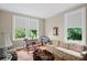 Living room with hardwood floors and windows overlooking green landscape at 655 E Pelham Ne Rd, Atlanta, GA 30324