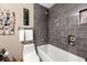 Well-lit bathroom with gray subway tile in the shower and a soaking tub for relaxation at 1141 Moorestown Cir, Decatur, GA 30033