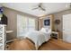 Cozy bedroom featuring a murphy bed, hardwood floors, and a ceiling fan at 1141 Moorestown Cir, Decatur, GA 30033