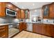 Well-equipped kitchen with stainless steel appliances, wooden cabinets, and ample counter space at 1141 Moorestown Cir, Decatur, GA 30033