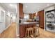 Modern kitchen featuring a breakfast bar, stainless steel appliances, and wooden cabinetry at 1141 Moorestown Cir, Decatur, GA 30033