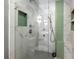 Luxurious shower with white marble walls, green accent tiles, and a built-in niche at 1141 Moorestown Cir, Decatur, GA 30033