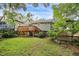 View of the backyard featuring a well-maintained lawn, deck, and lush foliage at 1231 Mansfield Ne Ave, Atlanta, GA 30307