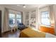 Cozy bedroom with hardwood floors, built in shelving, and natural light from large windows at 1231 Mansfield Ne Ave, Atlanta, GA 30307