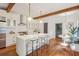 Bright kitchen featuring a large island with seating, stainless steel appliances, and wooden beam accents at 1231 Mansfield Ne Ave, Atlanta, GA 30307
