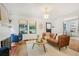 Cozy living room featuring a brick fireplace, hardwood floors, and natural light at 1231 Mansfield Ne Ave, Atlanta, GA 30307