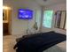 This bedroom includes a flat screen TV, a full-length mirror, and a connected bathroom at 116 Madeline Ct, Mcdonough, GA 30253