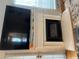 Close-up of a modern fireplace with a mounted TV, surrounded by white trim and a window at 116 Madeline Ct, Mcdonough, GA 30253